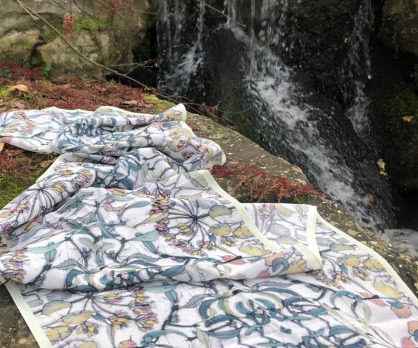 Softly our Shades of Winter Silk Crepe de Chine scarf slithering through lichen covered stone.